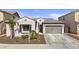 Charming home with a two-car garage, complemented by desert landscaping and a well-maintained lawn at 23097 N 95Th Dr, Peoria, AZ 85383