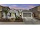 Charming single-story home with a two-car garage, desert landscaping and a neutral color scheme at 23097 N 95Th Dr, Peoria, AZ 85383
