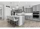 Contemporary kitchen featuring an island with bar seating, modern pendant lights, and plenty of cabinet space at 23097 N 95Th Dr, Peoria, AZ 85383