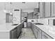 Bright and airy kitchen with a large island, stainless steel appliances, white countertops, and stylish grey cabinets at 23097 N 95Th Dr, Peoria, AZ 85383