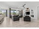 Spacious living room features tile floors, a ceiling fan, a large window with a view, and a built-in entertainment center at 23097 N 95Th Dr, Peoria, AZ 85383