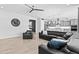 Cozy living room with a leather sectional sofa, ceiling fan, and views of the open kitchen and dining area at 23097 N 95Th Dr, Peoria, AZ 85383