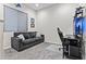 Cozy living room features carpet, comfortable sofa, and entertainment center at 23097 N 95Th Dr, Peoria, AZ 85383