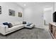 Cozy living room featuring carpet, comfortable sofa, and entertainment center at 23097 N 95Th Dr, Peoria, AZ 85383