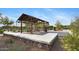 An outdoor picnic area offers a shaded shelter, tables, and nearby grill, perfect for community gatherings at 23097 N 95Th Dr, Peoria, AZ 85383