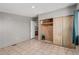A spacious bedroom with wood paneling and tile flooring features a large closet and attached bathroom at 245 S 56Th St # 135, Mesa, AZ 85206