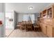Bright dining room with a wooden table and chairs, adjacent to the kitchen, perfect for Gathering meals at 245 S 56Th St # 135, Mesa, AZ 85206