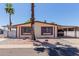 Well-maintained single-story home featuring a carport and neat landscaping with a central palm tree at 245 S 56Th St # 135, Mesa, AZ 85206