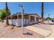 Corner lot featuring desert landscaping, carport, and welcoming curb appeal, perfect for easy living at 245 S 56Th St # 135, Mesa, AZ 85206
