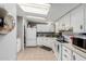Cozy kitchen with white cabinetry, appliances, and a skylight providing natural light at 245 S 56Th St # 135, Mesa, AZ 85206