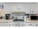 Close-up of kitchen countertop with appliances and white cabinets above the stove at 245 S 56Th St # 135, Mesa, AZ 85206