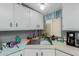 Kitchen sink area featuring updated faucet, white cabinetry, and countertop space at 245 S 56Th St # 135, Mesa, AZ 85206