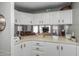 Open kitchen design with white cabinets, ample counter space and view to living area at 245 S 56Th St # 135, Mesa, AZ 85206