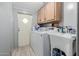 Practical laundry room with washer, dryer, sink, and storage cabinets for convenient chores at 245 S 56Th St # 135, Mesa, AZ 85206