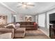 Comfortable living room featuring a ceiling fan, a sectional sofa, and a welcoming, cozy ambiance at 245 S 56Th St # 135, Mesa, AZ 85206