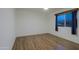 Clean, empty bedroom showcasing natural light, new flooring, and a serene atmosphere, ready for personalization at 3054 W Redfield Rd, Phoenix, AZ 85053