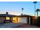 Charming single-story home featuring a spacious two-car garage and well-maintained landscaping under a beautiful evening sky at 3054 W Redfield Rd, Phoenix, AZ 85053
