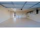 Well-lit garage equipped with storage options, laundry machines, and epoxy flooring at 3054 W Redfield Rd, Phoenix, AZ 85053