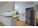 Bright kitchen features stainless steel appliances, white cabinets, and tile floors at 3054 W Redfield Rd, Phoenix, AZ 85053