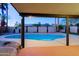 Beautiful pool, large patio area with tropical palms, and modern lighting offer a tranquil outdoor experience at 3054 W Redfield Rd, Phoenix, AZ 85053