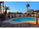 Sparkling pool area with surrounding rock accents, block wall, and tropical palm trees creating a private oasis at 3054 W Redfield Rd, Phoenix, AZ 85053