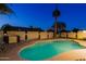 Serene pool area surrounded by a privacy wall and swaying palm trees, creating a secluded desert escape at 3054 W Redfield Rd, Phoenix, AZ 85053