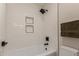 The bathroom includes a soaking tub with white subway tile surround, black fixtures, and built-in shelving at 33287 N Windmill Run, San Tan Valley, AZ 85144