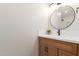 The bathroom vanity features wood-look cabinets, black hardware, and a sink with a white countertop at 33287 N Windmill Run, San Tan Valley, AZ 85144