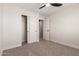 This bedroom has carpet, an open closet, and easy access to an additional room for extra storage or living space at 33287 N Windmill Run, San Tan Valley, AZ 85144