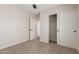 This bedroom has carpet, an open closet, and easy access to an additional room for extra storage or living space at 33287 N Windmill Run, San Tan Valley, AZ 85144