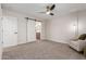 Bright bedroom with barn door leading to the bathroom, with natural light and a ceiling fan at 33287 N Windmill Run, San Tan Valley, AZ 85144
