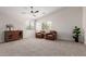 Bonus room with vaulted ceiling, plush carpet, and two leather armchairs in a seating arrangement at 33287 N Windmill Run, San Tan Valley, AZ 85144