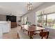 Bright dining room with a wood table, bench seating, and sliding glass doors to outdoor space at 33287 N Windmill Run, San Tan Valley, AZ 85144