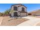 Charming two-story home with a well-manicured front yard and a two-car garage, painted in neutral colors at 33287 N Windmill Run, San Tan Valley, AZ 85144