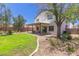 Back view of home with a covered patio and a well-manicured lawn at 33287 N Windmill Run, San Tan Valley, AZ 85144