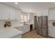 Bright kitchen showcasing white countertops and cabinets, stainless steel appliances, and modern fixtures at 33287 N Windmill Run, San Tan Valley, AZ 85144