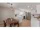 Modern kitchen featuring white cabinets, stainless steel appliances, updated lighting, and a breakfast nook at 33287 N Windmill Run, San Tan Valley, AZ 85144