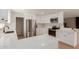 Modern kitchen featuring white cabinets, stainless steel appliances, quartz countertops, and updated fixtures at 33287 N Windmill Run, San Tan Valley, AZ 85144