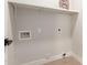 Bright laundry room featuring white shelving and hookups for washer and dryer at 33287 N Windmill Run, San Tan Valley, AZ 85144
