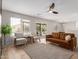 Spacious living room with a ceiling fan, sliding glass doors to the patio, and ample natural light at 33287 N Windmill Run, San Tan Valley, AZ 85144