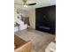 Cozy living room with modern electric fireplace and wood-look flooring, complemented by a neutral color palette at 33287 N Windmill Run, San Tan Valley, AZ 85144