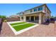 Backyard featuring a covered patio and artificial turf at 3361 E Wisteria Pl, Chandler, AZ 85286