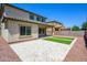 Large backyard featuring travertine tile patio with artificial turf inserts at 3361 E Wisteria Pl, Chandler, AZ 85286