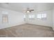Spacious bedroom with carpet, a ceiling fan, and an abundance of natural light from multiple windows at 3361 E Wisteria Pl, Chandler, AZ 85286
