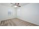 Empty bedroom with carpet, a ceiling fan, and an abundance of natural light from multiple windows at 3361 E Wisteria Pl, Chandler, AZ 85286