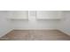 Spacious walk-in closet with neutral carpet and ample shelving ready for storage at 3361 E Wisteria Pl, Chandler, AZ 85286