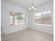 Bright dining area features neutral tile flooring, a modern light fixture, and natural light through two large windows at 3361 E Wisteria Pl, Chandler, AZ 85286