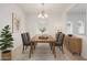 Elegant dining room featuring a wooden table, six chairs, chandelier, and stylish decor at 3361 E Wisteria Pl, Chandler, AZ 85286