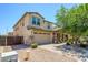 Charming two-story home with tan stucco, a tile roof, stone accents, and a large two car garage at 3361 E Wisteria Pl, Chandler, AZ 85286