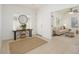 Inviting foyer with console table, round mirror, and a glimpse into the cozy living area at 3361 E Wisteria Pl, Chandler, AZ 85286